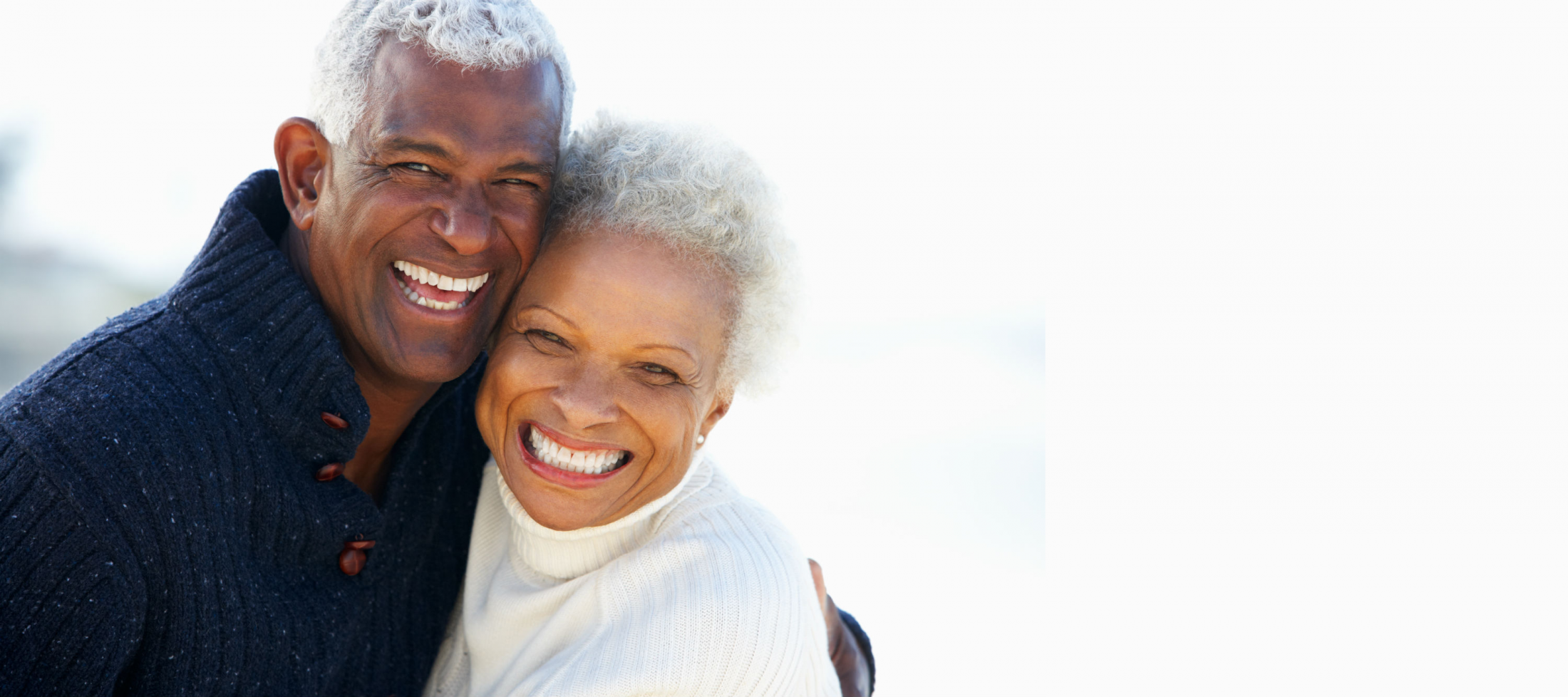 an elderly black couple smiling